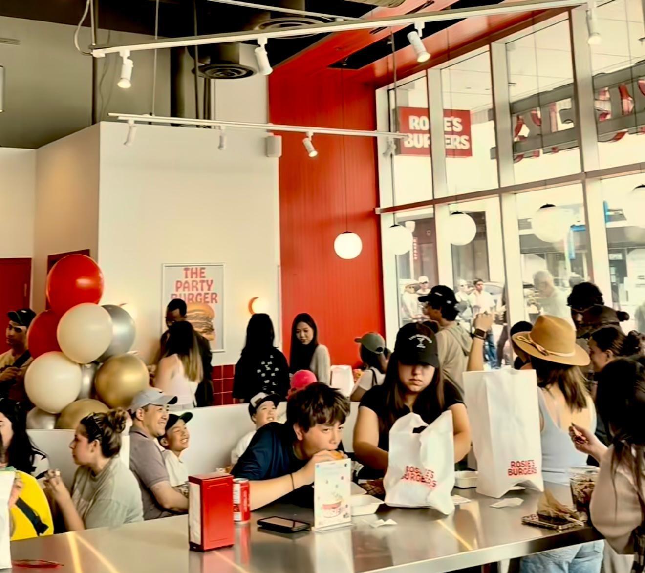 A group of people sitting at a table in a restaurant

AI-generated content may be incorrect.