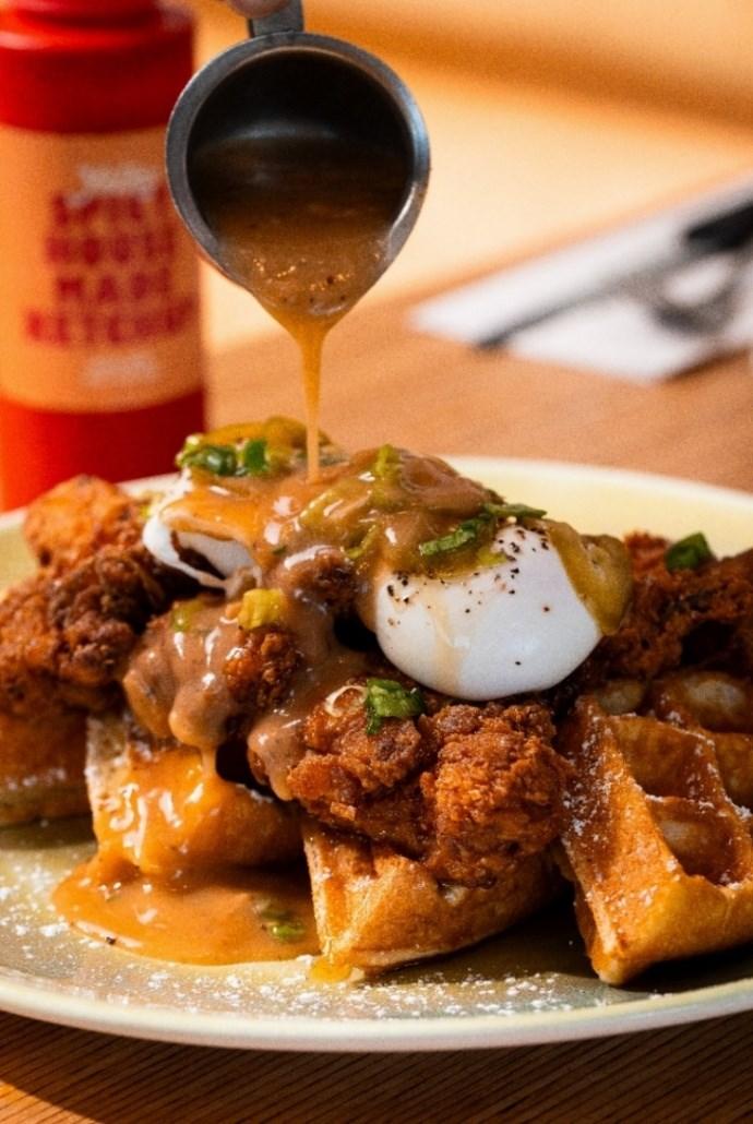 A plate of food with sauce being poured onto it

AI-generated content may be incorrect.