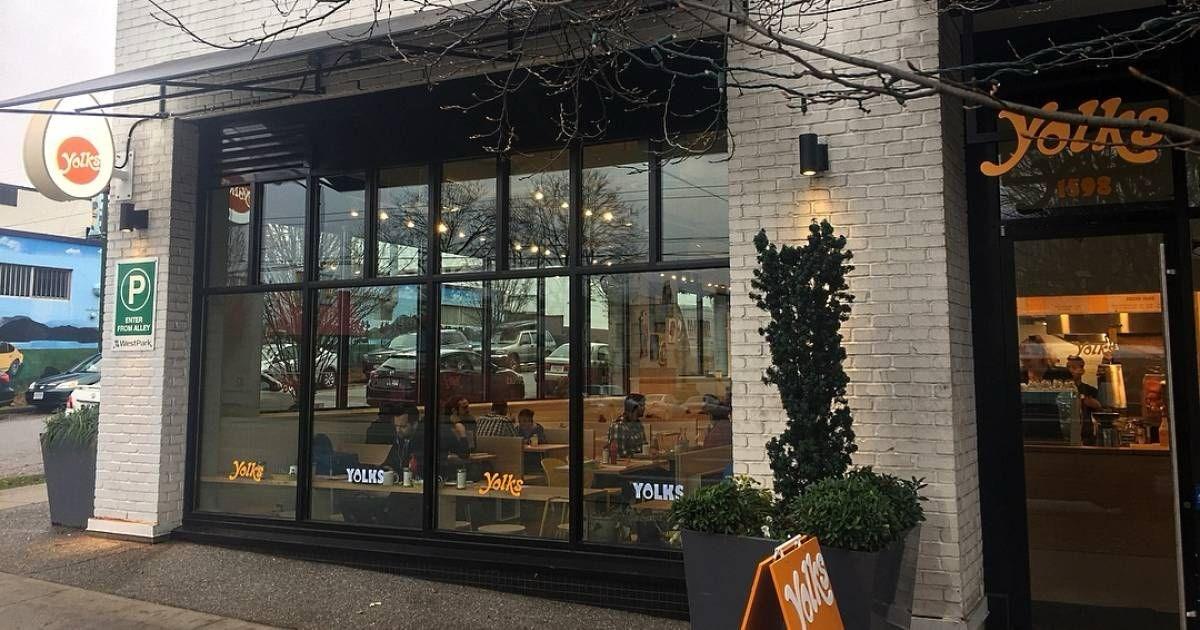 Yolks is a restaurant with a brick exterior, large glass windows, and a decorative entrance.

AI-generated content may be incorrect.